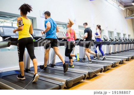 Fit people jogging on treadmills 19198807