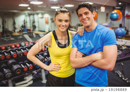 Fit couple smiling at camera 19198889