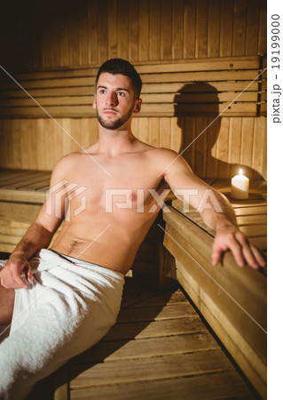 Man sitting inside a sauna 19199000