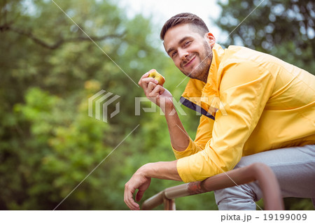Fit man eating an apple Fit man eating an apple 19199009