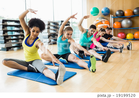 Fitness class exercising in the studio Fitness class exercising in the studio 19199520