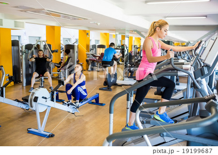 Fit people working out using machines Fit people working out using machines 19199687