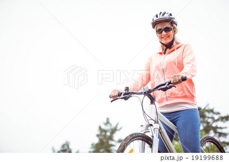 Happy woman on a bike ride Happy woman on a bike ride 19199688