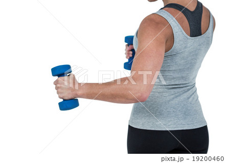 Muscular woman working out with dumbbells 19200460