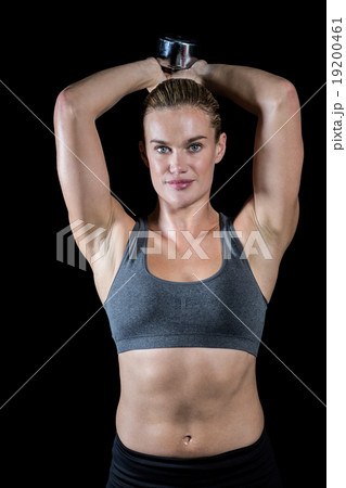 Muscular woman lifting heavy dumbbells Muscular woman lifting heavy dumbbells 19200461