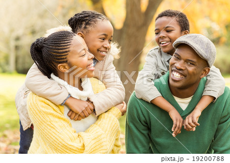 Portrait of a young smiling family in piggyback 19200788