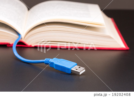 Usb cable sticks out from red book Usb cable sticks out from red book 19202408