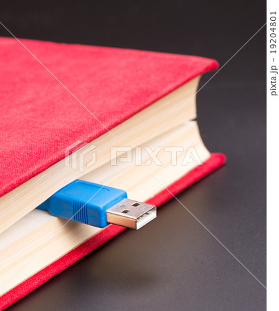 Usb cable sticks out from red book 19204801