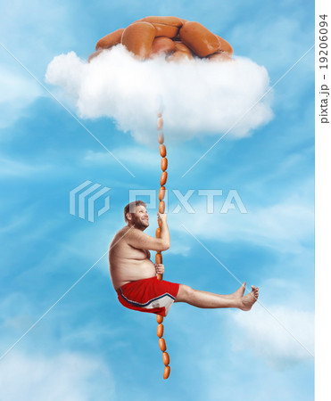 Man hanging on the sausage rope 19206094
