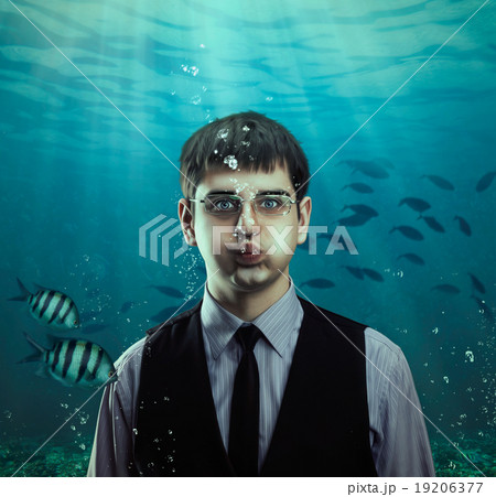 Underwater scene of a businessman with fishes Underwater scene of a businessman with fishes 19206377