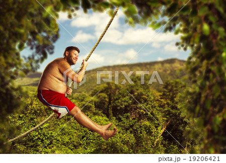 Man flying in the air by rope 19206421