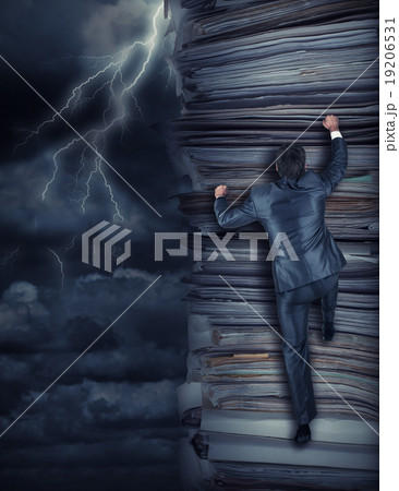 Businessmen climbing up at storm 19206531