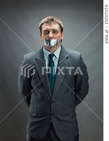 Man with mouth covered by masking tape Man with mouth covered by masking tape 19207019