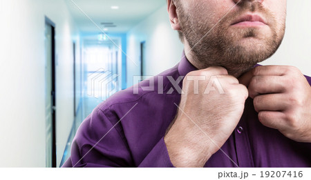 Bearded man buttons his shirt 19207416