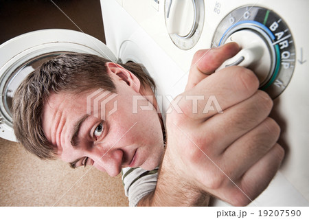 Surprised man inside washing machine 19207590