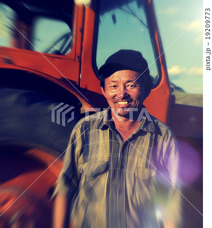 Smiling Mongolian Farmer Standing Next Tractor Concept Smiling Mongolian Farmer Standing Next Tractor Concept 19209773