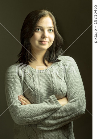 Portrait of a smiling pretty teenage brunette  19210465