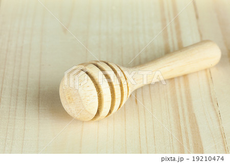 honey dipper without honey on wooden background 19210474