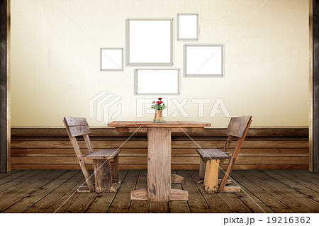 Picture frames and old wood chair in room 19216362