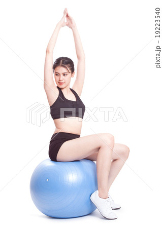 woman doing stretching fitness exercise on ball 19223540