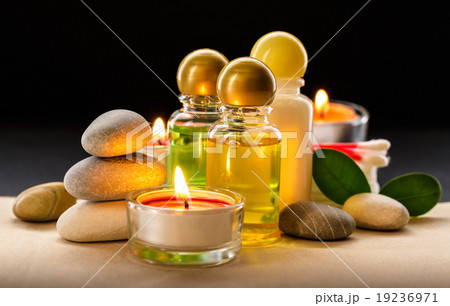 Spa stones, candle and shampoo bottles 19236971