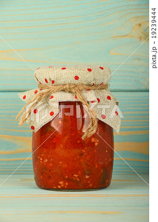 Jar of pepper salad at vintage wood surface Jar of pepper salad at vintage wood surface 19239444