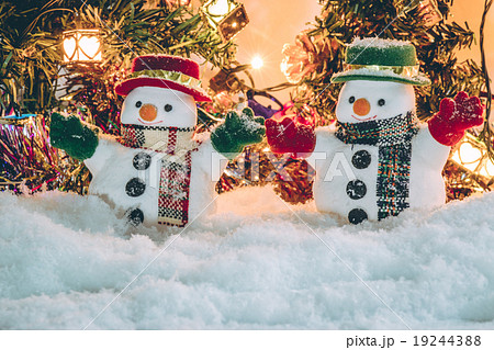 Snowman stand among pile of snow with a light bulb Snowman stand among pile of snow with a light bulb 19244388