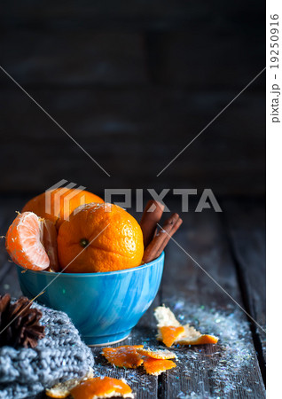 Tangerine in scarf over wooden background 19250916