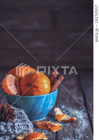 Tangerine in scarf over wooden background 19250917