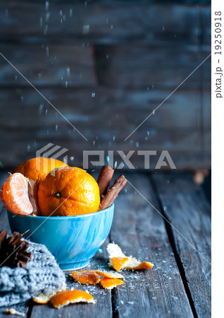 Tangerine in scarf over wooden background 19250918