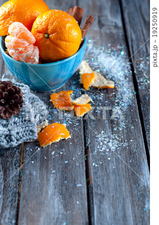 Tangerine in scarf over wooden background 19250919