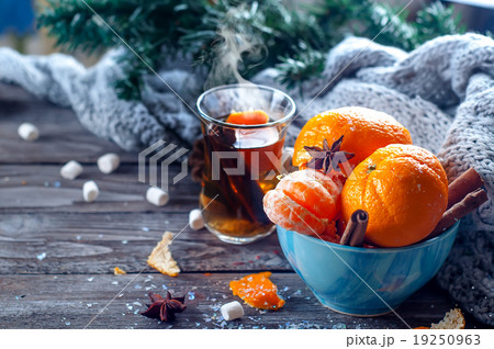 Tangerine in scarf over wooden background Tangerine in scarf over wooden background 19250963