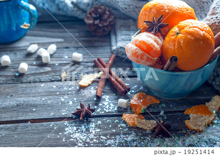 Tangerine in scarf over wooden background Tangerine in scarf over wooden background 19251414