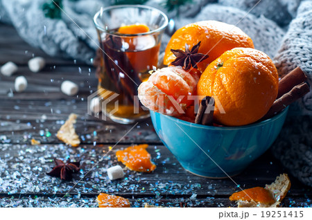 Tangerine in scarf over wooden background Tangerine in scarf over wooden background 19251415