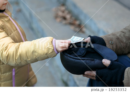 Somebody gives money to the beggar.  19253352