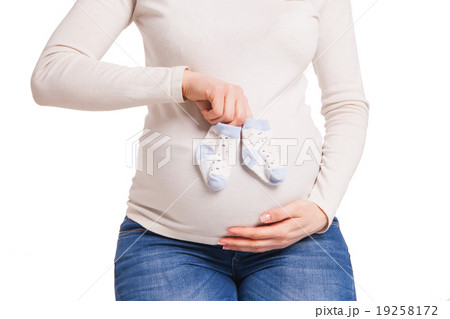 hands of happy pregnent woman holding child socks hands of happy pregnent woman holding child socks 19258172