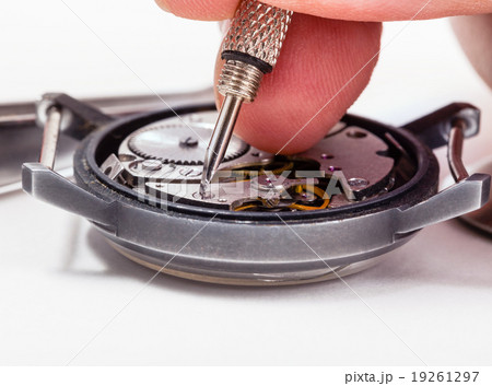 watch repairer repairs old watch close up 19261297