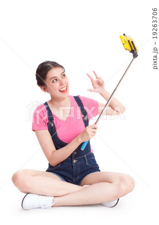 woman taking picture with smartphone selfie stick woman taking picture with smartphone selfie stick 19263706