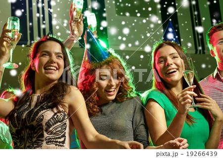 smiling friends with glasses of champagne in club smiling friends with glasses of champagne in club 19266439