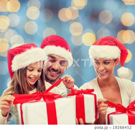happy family in santa hats sitting with gift boxes happy family in santa hats sitting with gift boxes 19266452