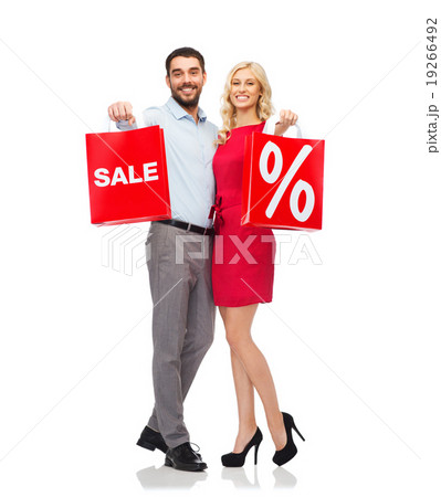 happy couple with red shopping bags happy couple with red shopping bags 19266492