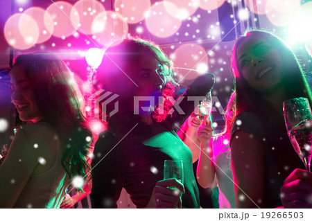 smiling friends with glasses of champagne in club smiling friends with glasses of champagne in club 19266503