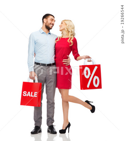 happy couple with red shopping bags happy couple with red shopping bags 19266544