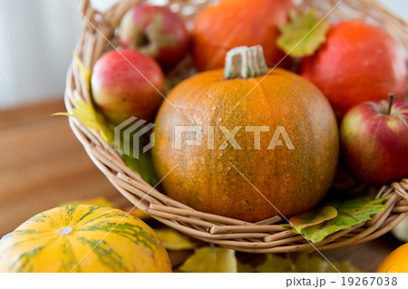 close up of pumpkins in basket on wooden table close up of pumpkins in basket on wooden table 19267038