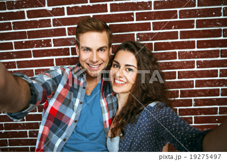 Concept for stylish young couple near brick wall Concept for stylish young couple near brick wall 19275497