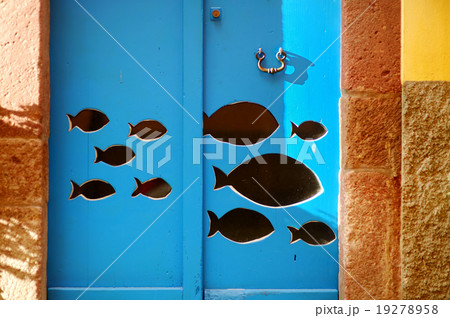 Fish cut out of blue door in Italy 19278958