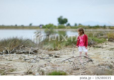 Little girl on Tigaki lake beach Little girl on Tigaki lake beach 19280035