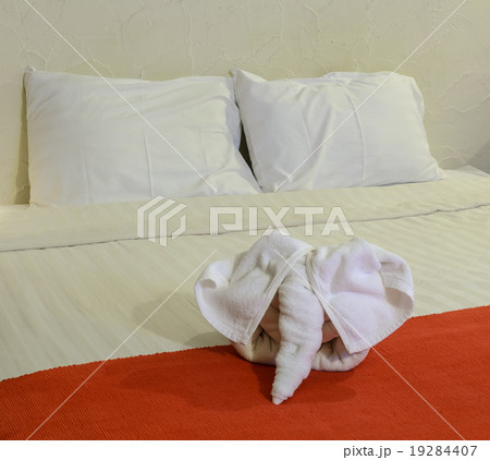 White towel in form of elephant on bed White towel in form of elephant on bed 19284407