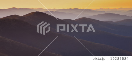 mountain peaks at sunset haze 19285684