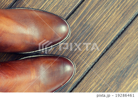 Brown Shoes on a Wooden Background Brown Shoes on a Wooden Background 19286461
